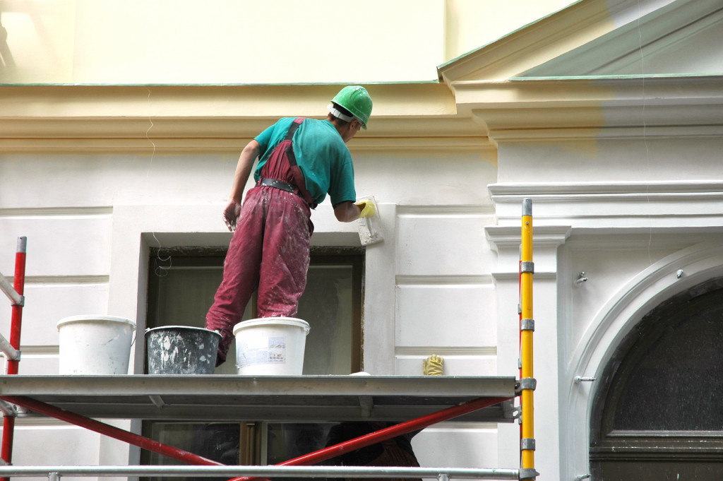 man painting the houses' exterior